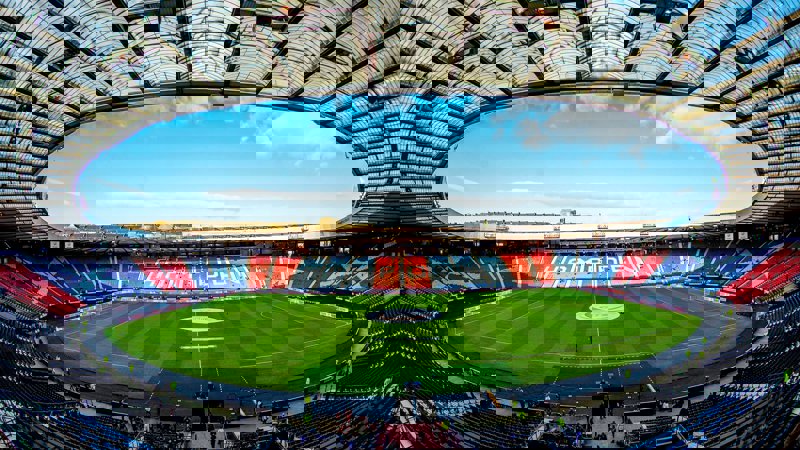 An overview of a large stadium with a blue sky overhead.