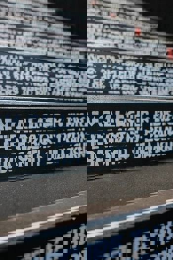 A close-up view of a staircase with the names of musicians who performed there, including Liam Gallagher and Lewis Capaldi.